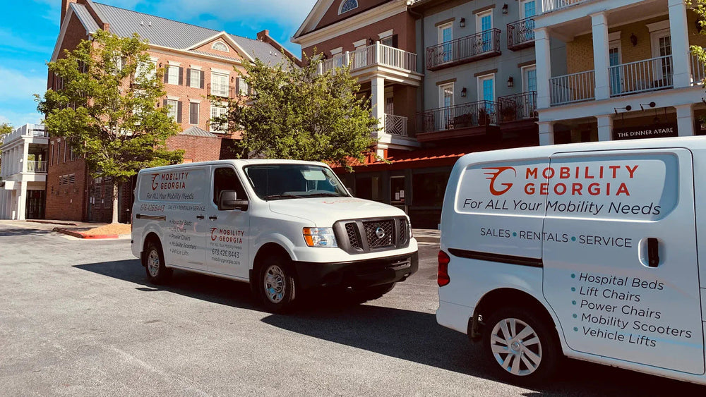 Two Mobility Georgia delivery vans parked outside a customer's home