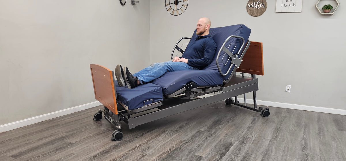 Man resting in the ActiveCare bed in chair position